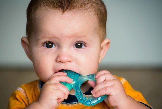 Child biting onto teething toy