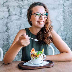 Woman eating healthy snack at table