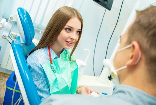 A female patient talking to her dentist