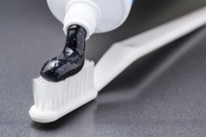 Activated charcoal on white toothbrush