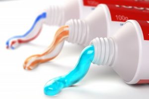 Three types of toothpaste squeezed from their respective tubes