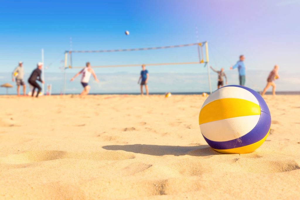 Closeup of yellow and blue volleyball on beach
